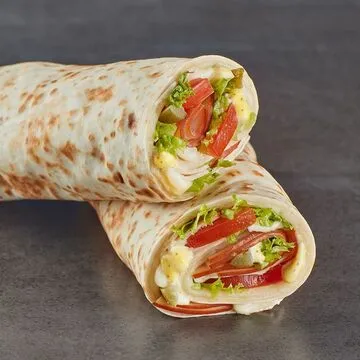 Operation Falafel falafel wrap topped with sauces