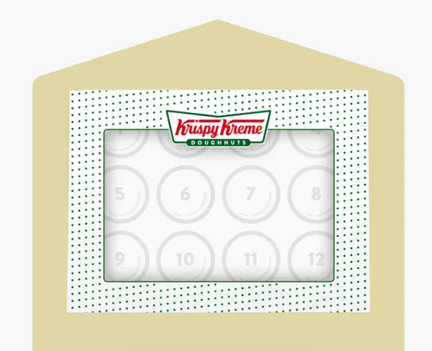 Krispy Kreme coffee cup beside doughnuts.