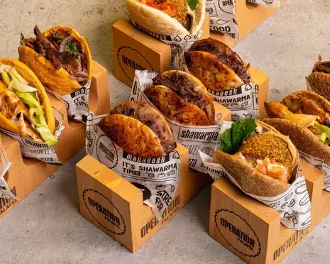 Operation Falafel menu featuring falafel, shawarma, and pita bread