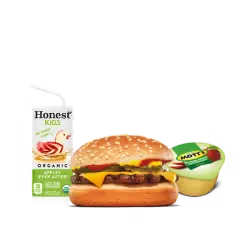 A thick King Burger patty topped with melted cheese and fresh vegetables with fries on the side.