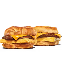 King Burger topped with melted cheese, lettuce, tomato, and sauce beside a serving of crispy fries