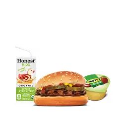 Close-up of a juicy King Burger with cheese melting over the patty and fries behind it.