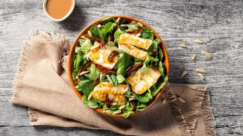 Customers enjoying meals at Zaatar W Zeit