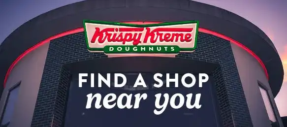 Krispy Kreme doughnuts cooling on the line.