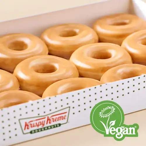 Hot Light Krispy Kreme doughnuts being prepared.